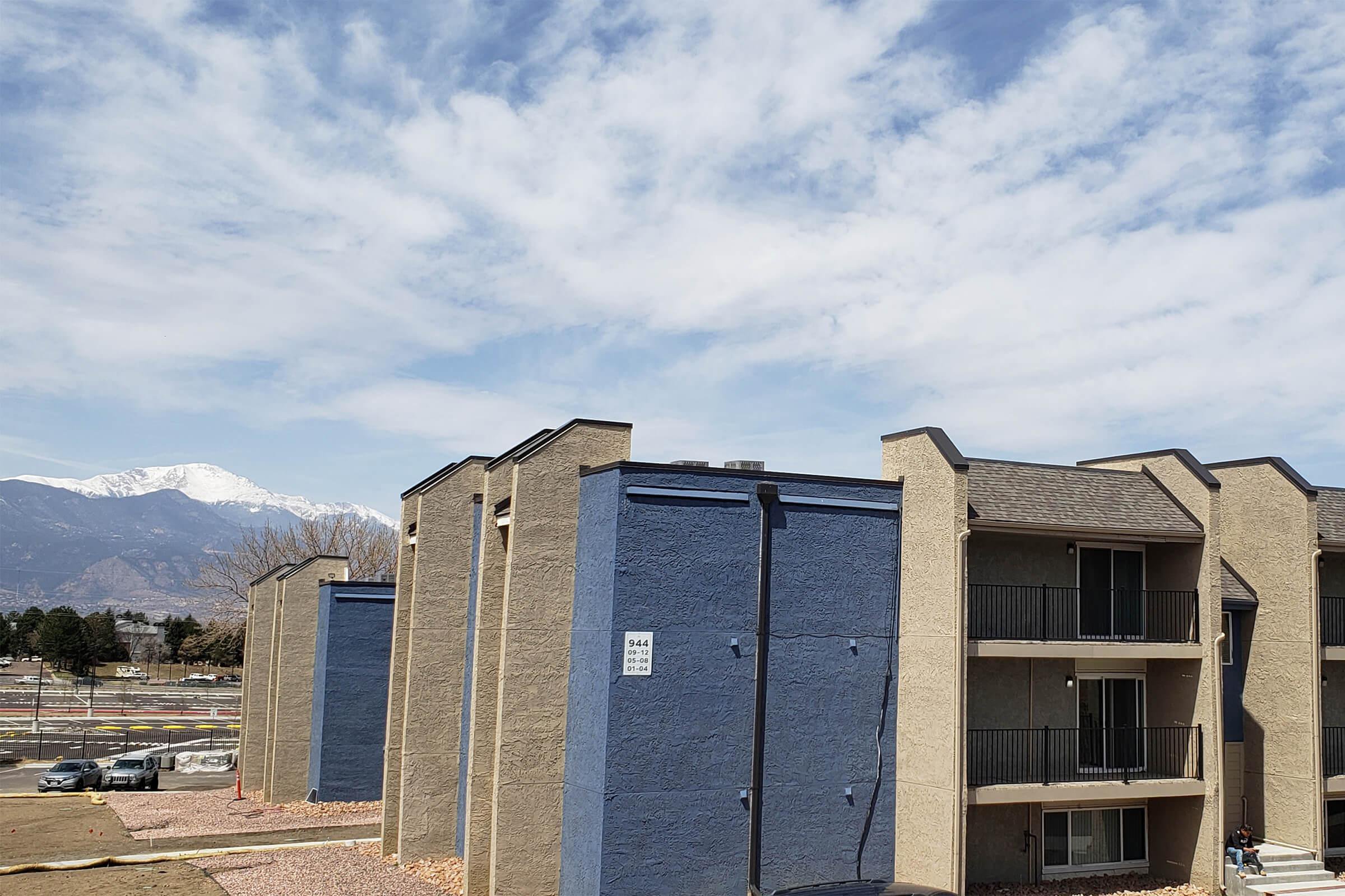 Buildings featuring balconies with a view of the mountains in the background at Parc at Prairie Grass, located in Colorado Springs, CO