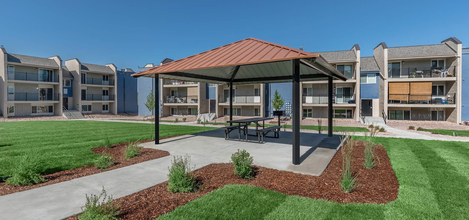 Pergola with outdoor dining and charcoal grill at Parc at Prairie Grass, located in Colorado Springs, CO
