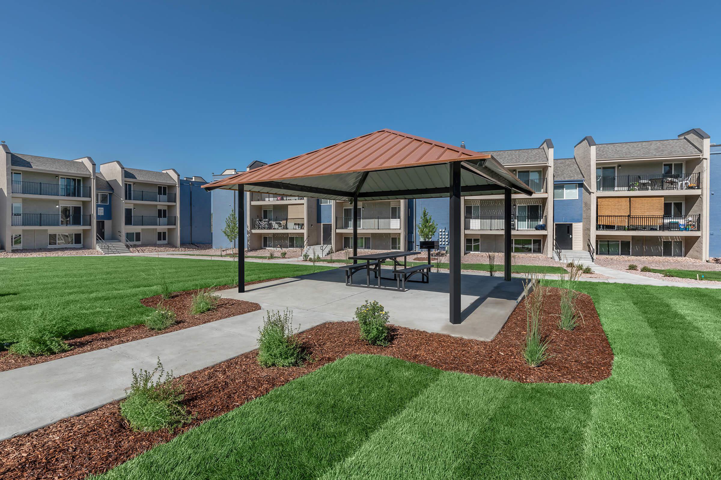 Pergola with outdoor dining and charcoal grill at Parc at Prairie Grass, located in Colorado Springs, CO